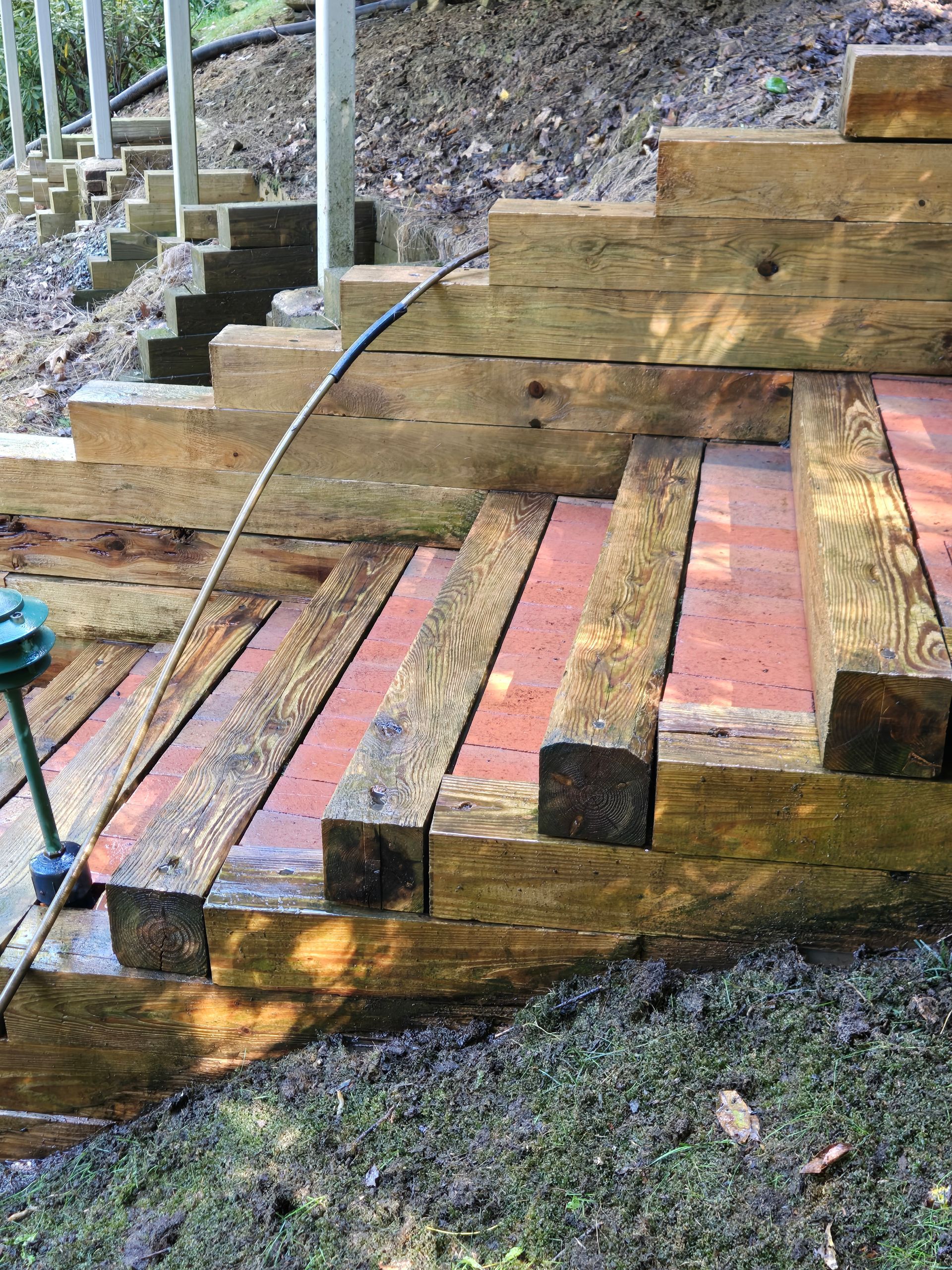 A wooden staircase with a hose attached to it.