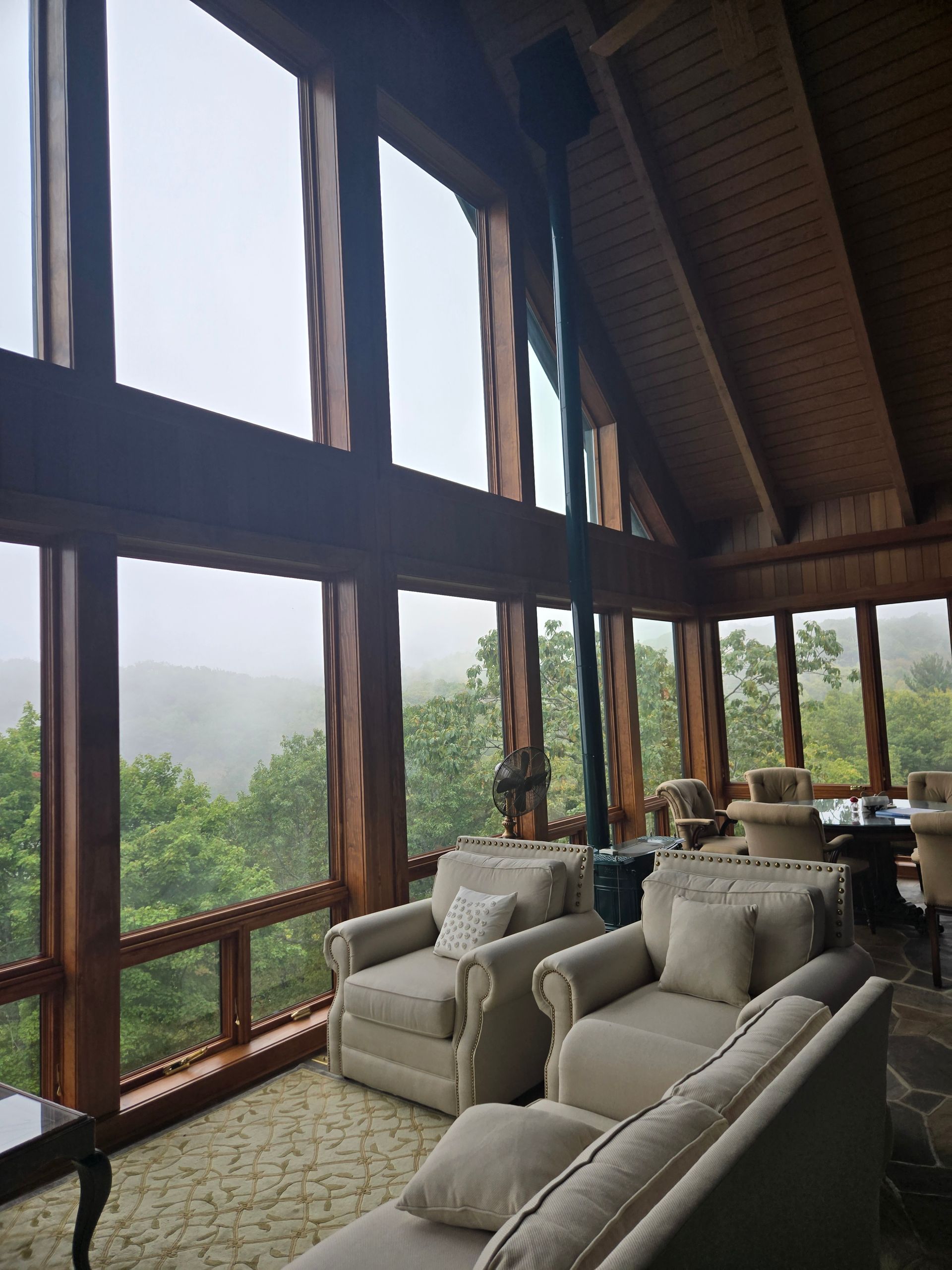 A living room with a lot of windows and furniture