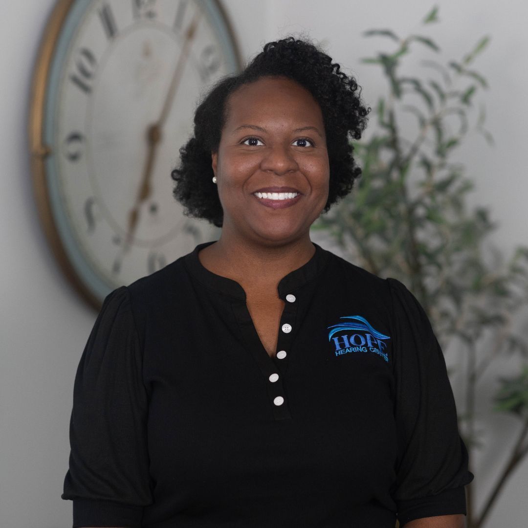 A woman wearing a black shirt with a blue butterfly on it
