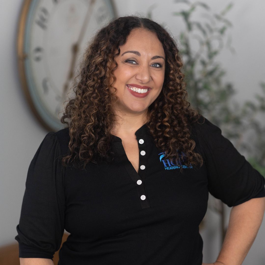 A woman wearing a black shirt with the word louisville on it