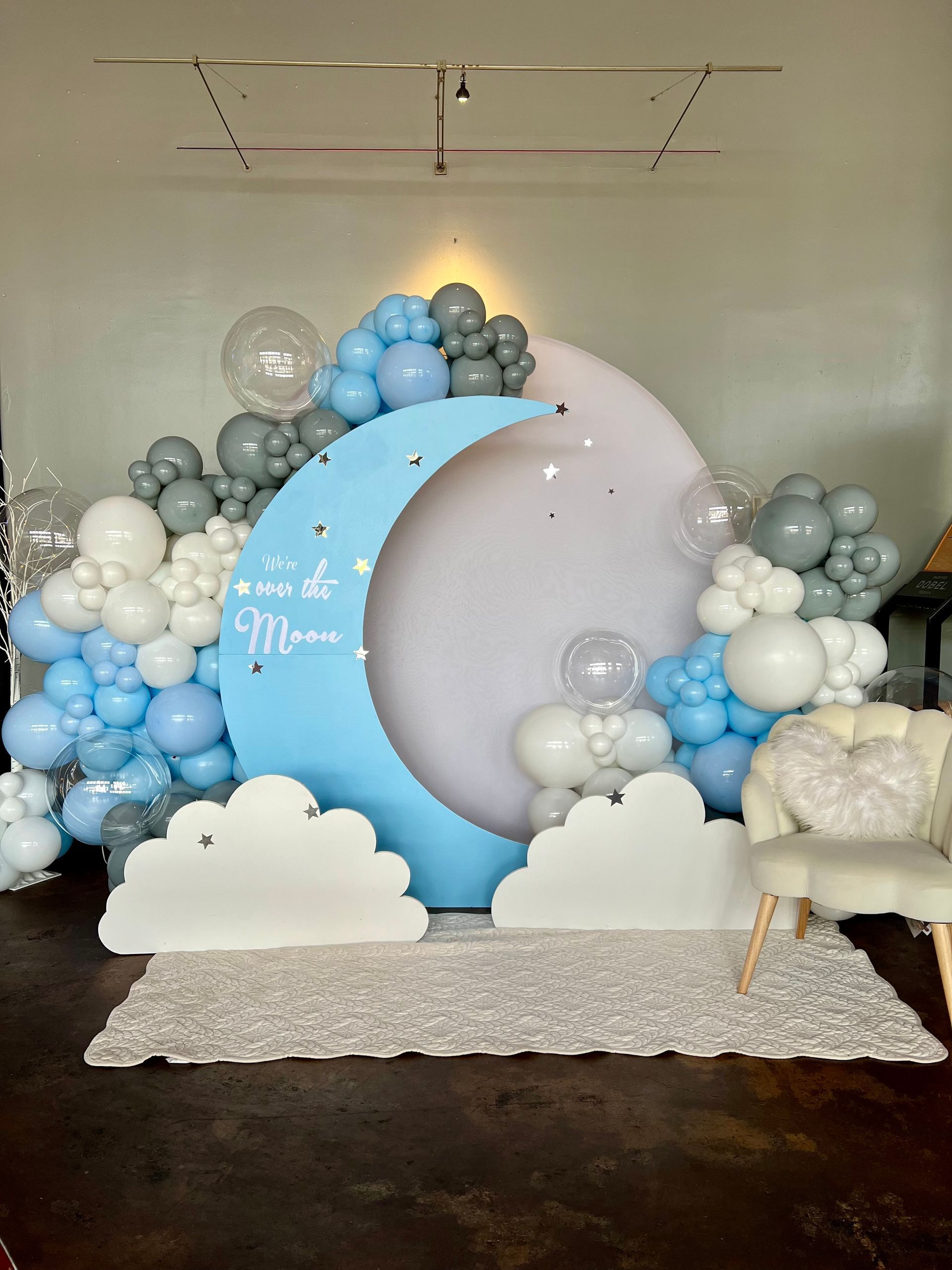 A room filled with balloons and a crescent moon.