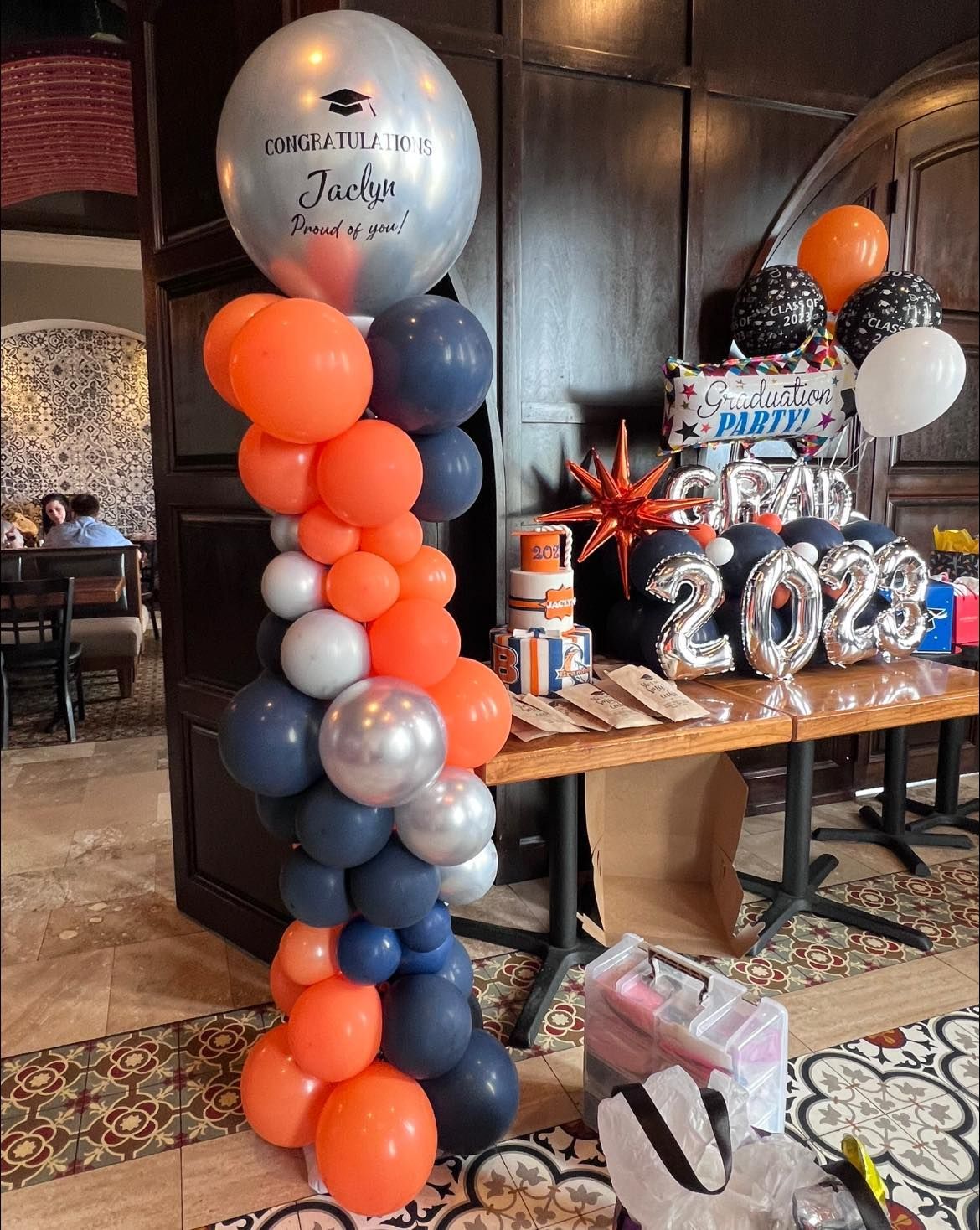 A bunch of balloons are sitting on top of a table in a room.