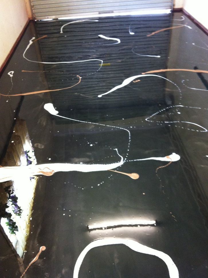 Black Surface With White and Brown Paint Splatters — Australian Epoxy Floors in Rockhampton, QLD