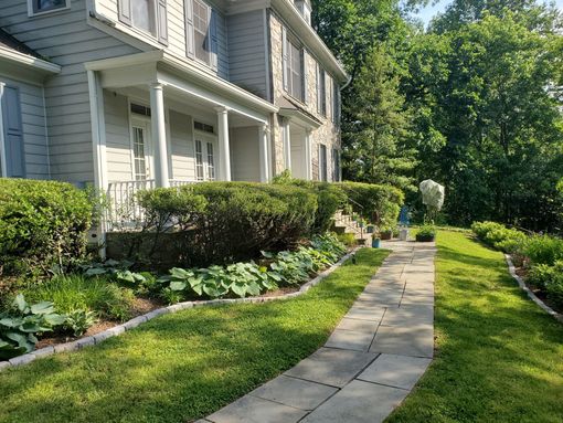 a stone walkway leading to the front of a house