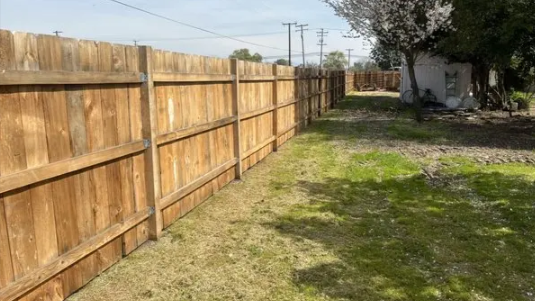 Custom Cut Lumber Fresno CA wooden fence built with precision boards by The Fence Company in Fresno 