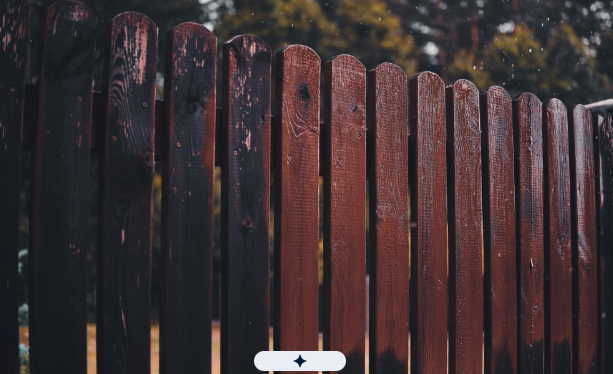 Damaged wooden fence showing signs of wear and requiring professional fence repair services in Fresn