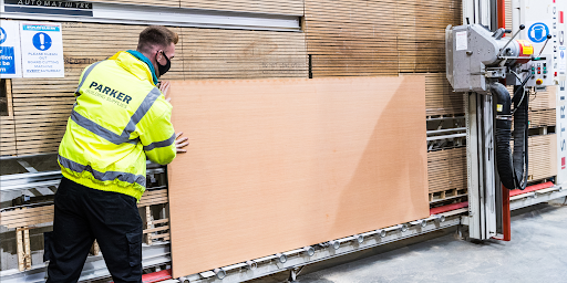 The Fence Company provides Lumber Cutting Services, Fresno, CA, while a man professionally cuts wood