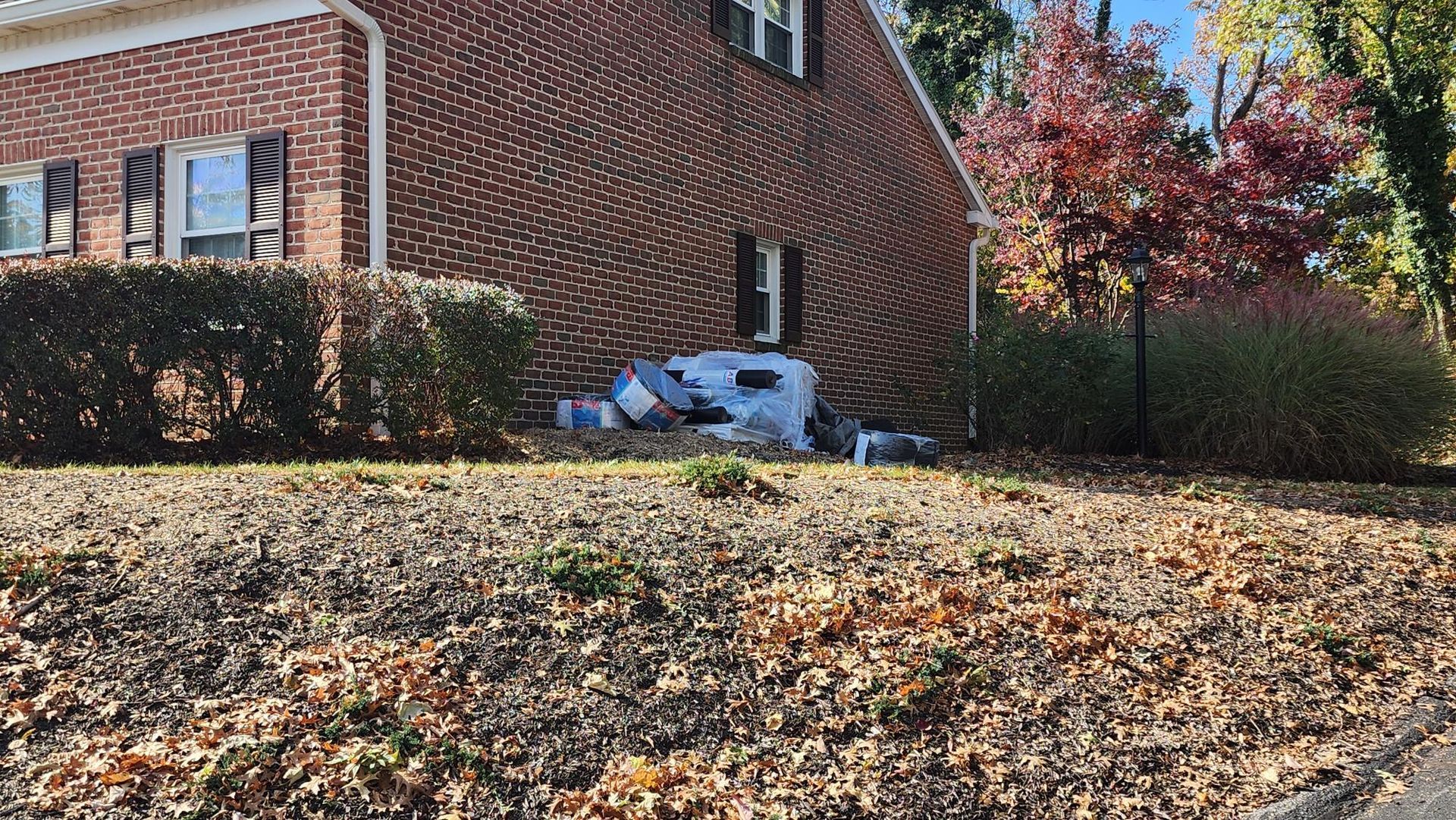 A brick house with a rv parked in front of it.