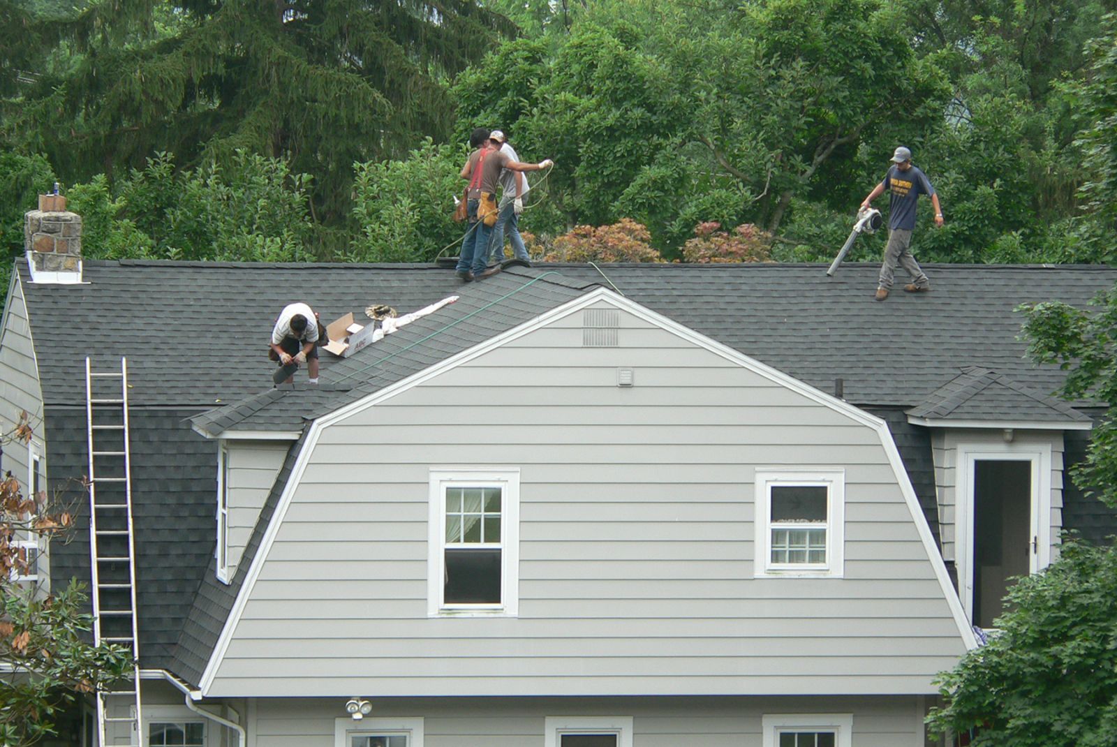 Workers working on the huge house roof — Mount Wolf, PA — Dover Roofing Services