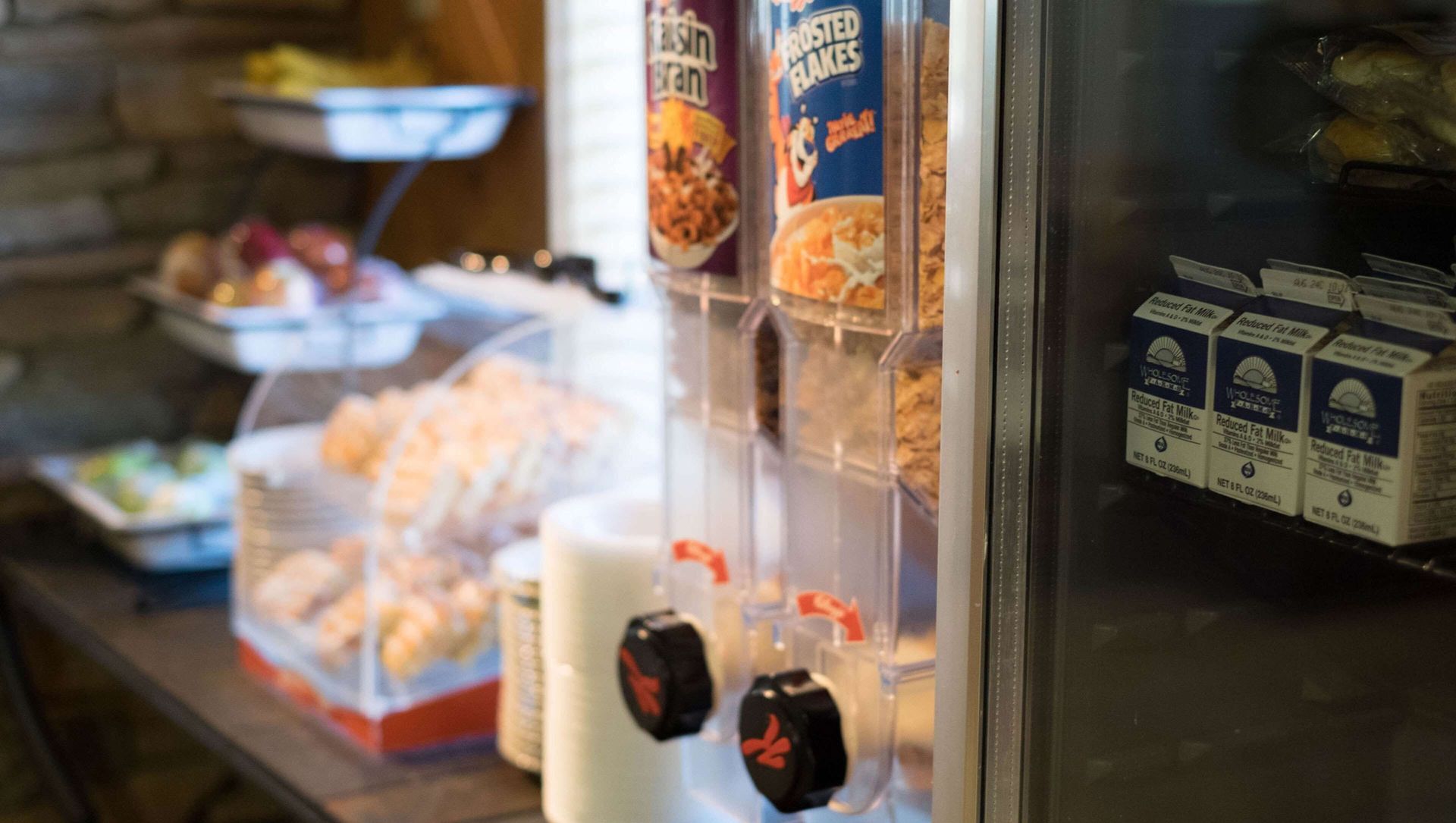 Restaurant soda fountain with drink dispensers, canned soups, and condiments on a counter