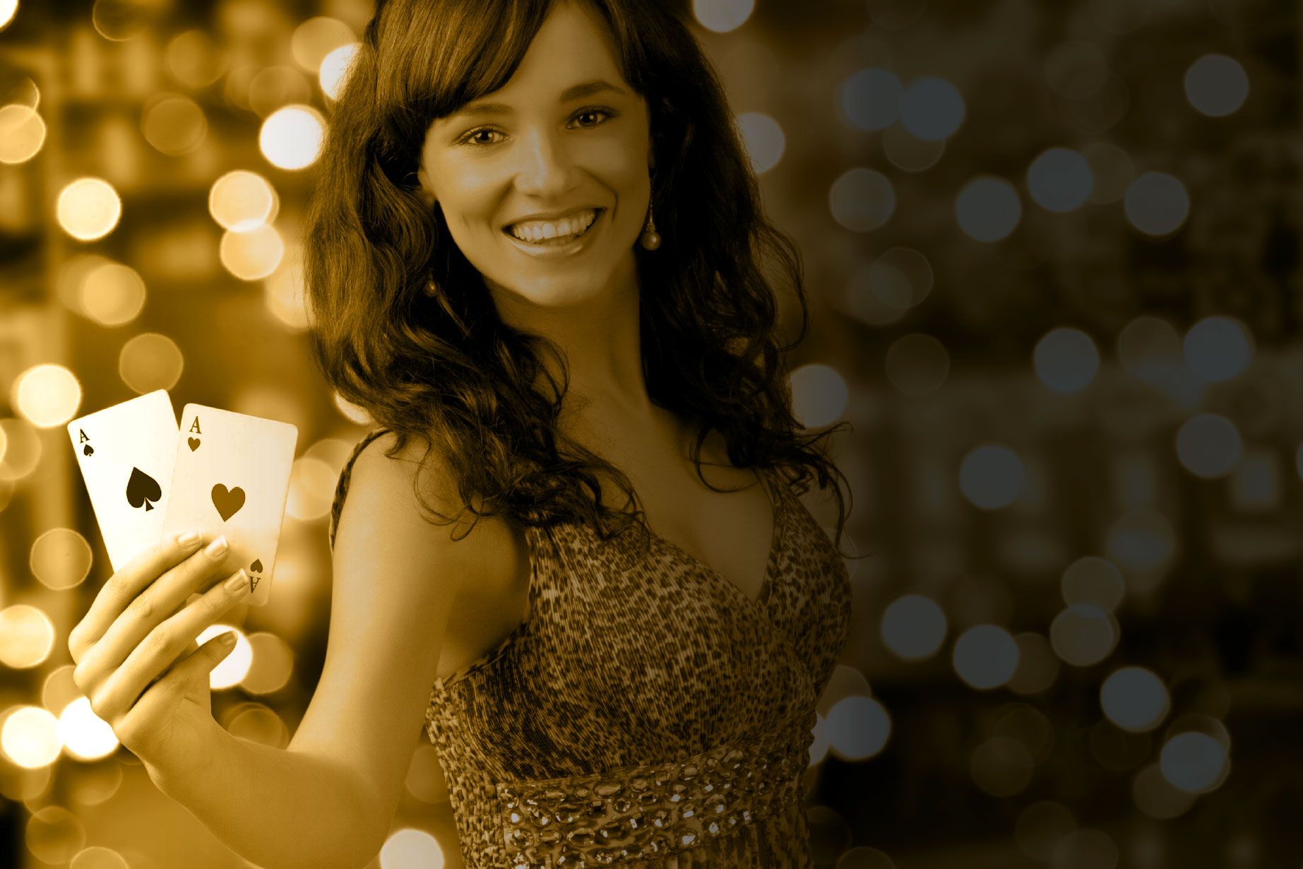 A woman in a dress is holding two playing cards in her hand.