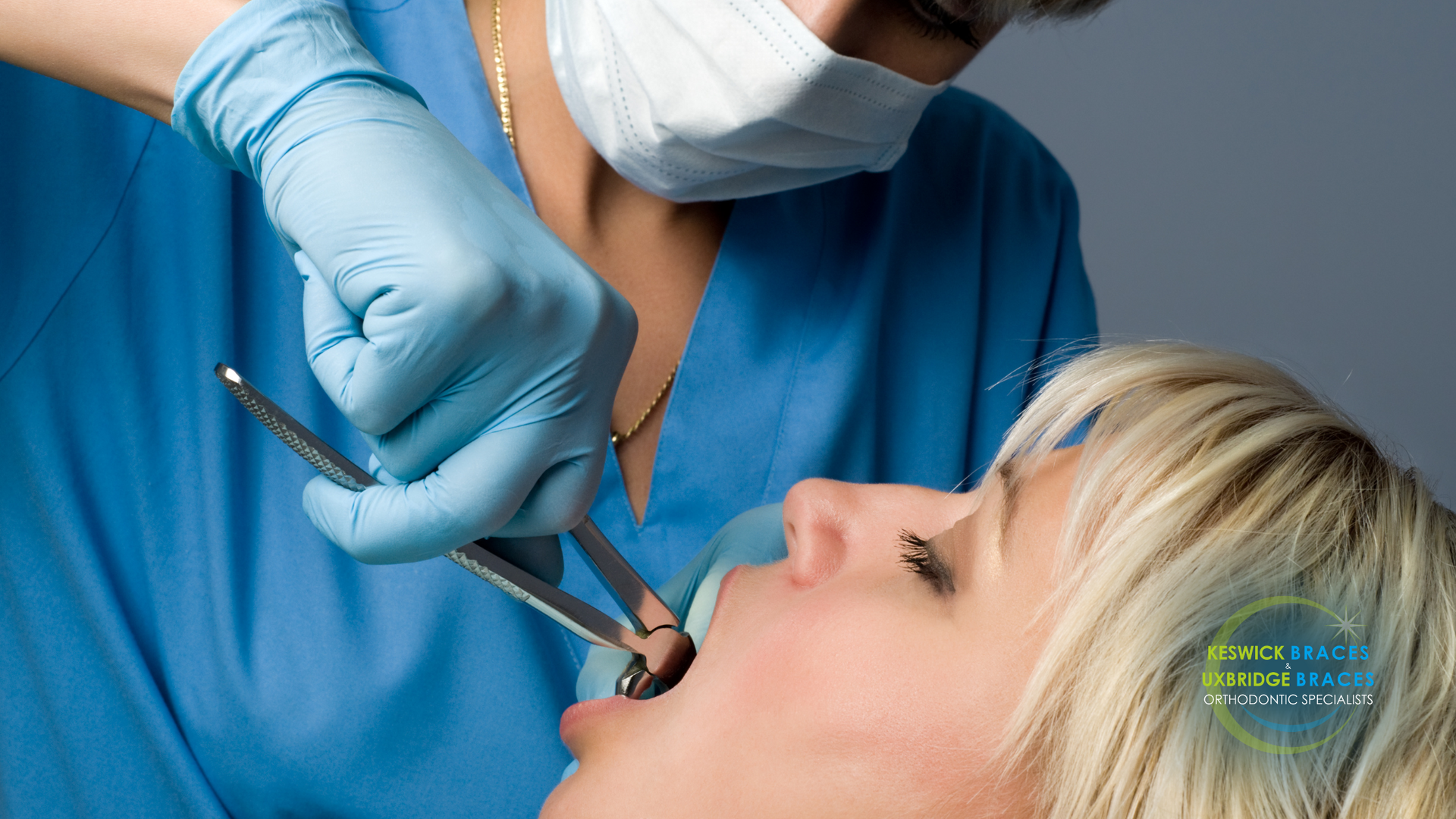 A woman is getting her teeth examined by a dentist