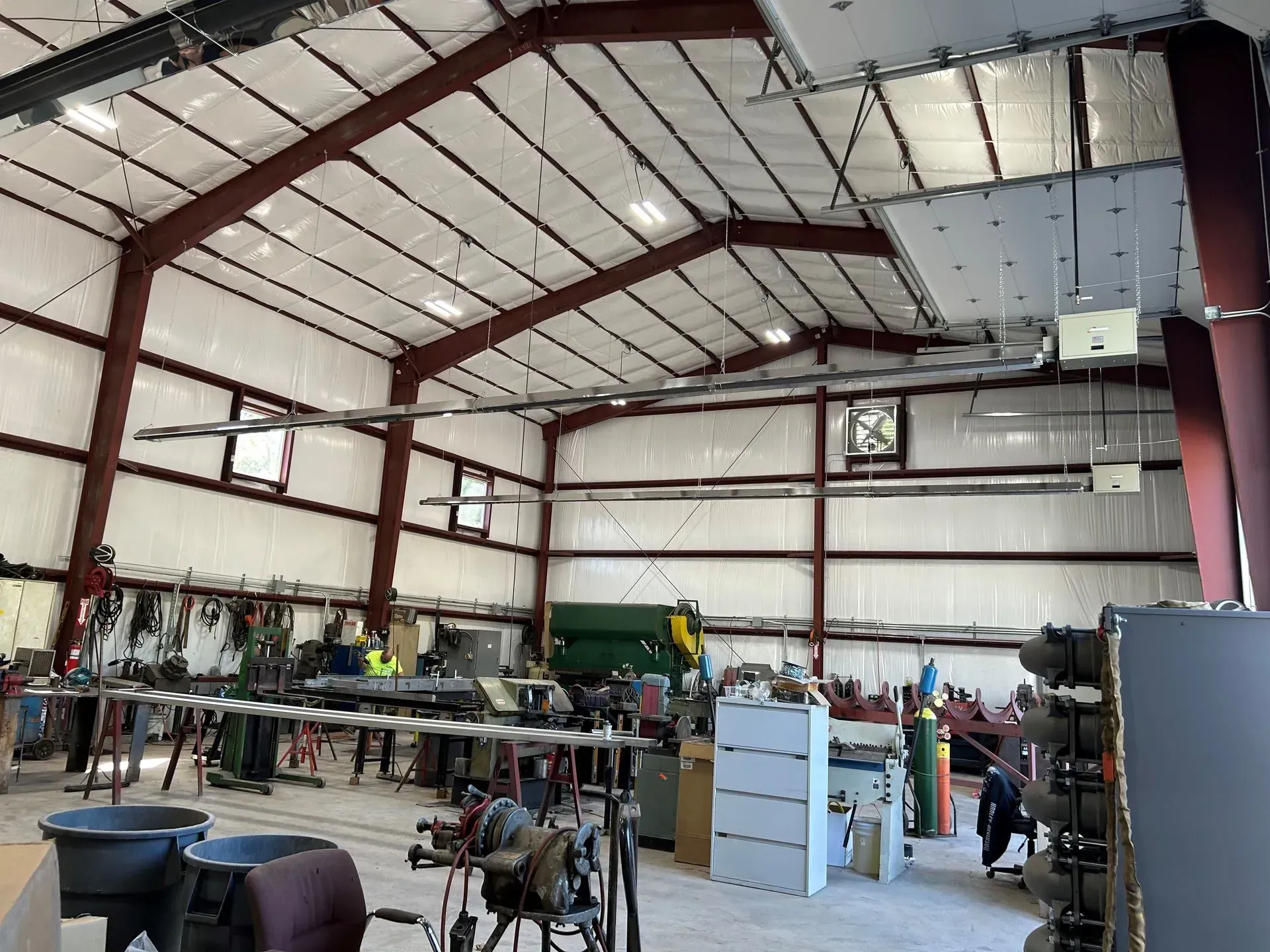 A large metal building with a lot of machinery inside of it.