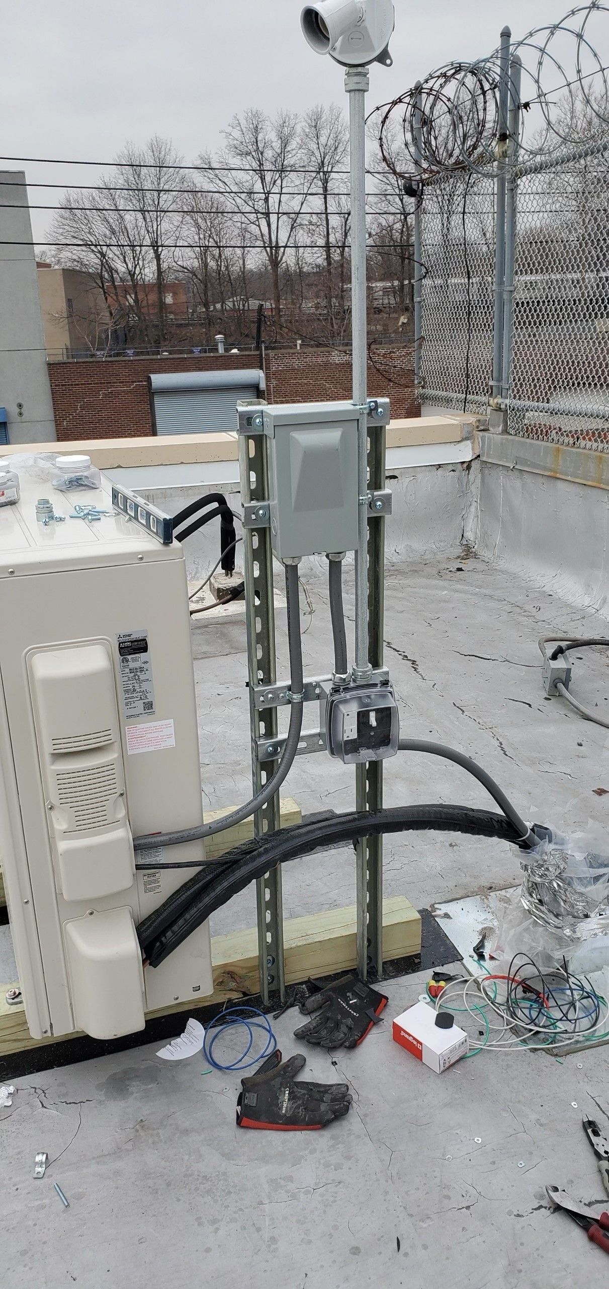 A rooftop with a lot of wires coming out of it