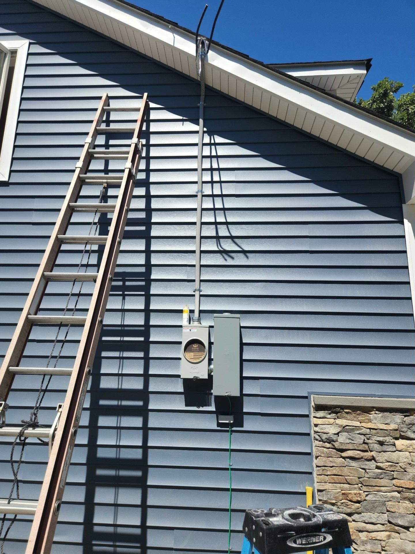 A ladder is leaning against the side of a house.