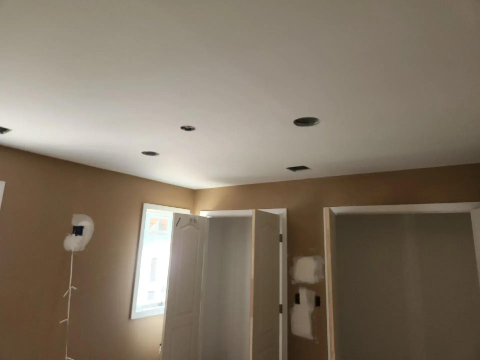 A room with a white ceiling and brown walls.