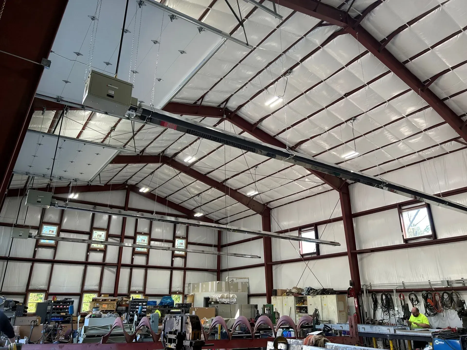 A large metal building with a ceiling fan hanging from it.