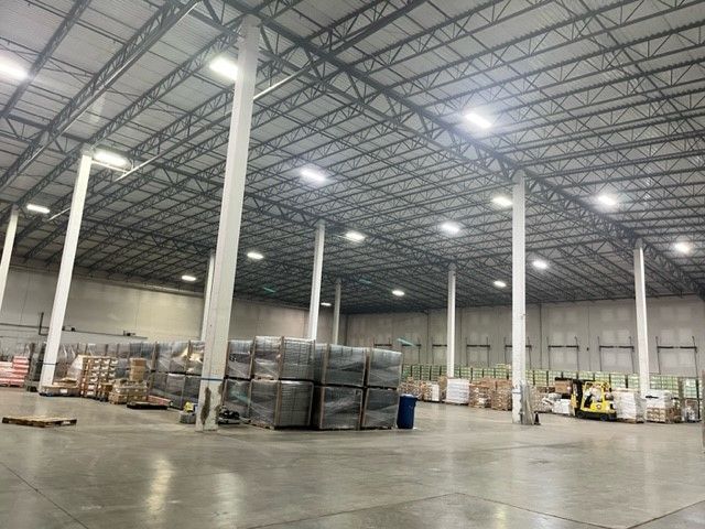 A large warehouse filled with lots of boxes and pallets.