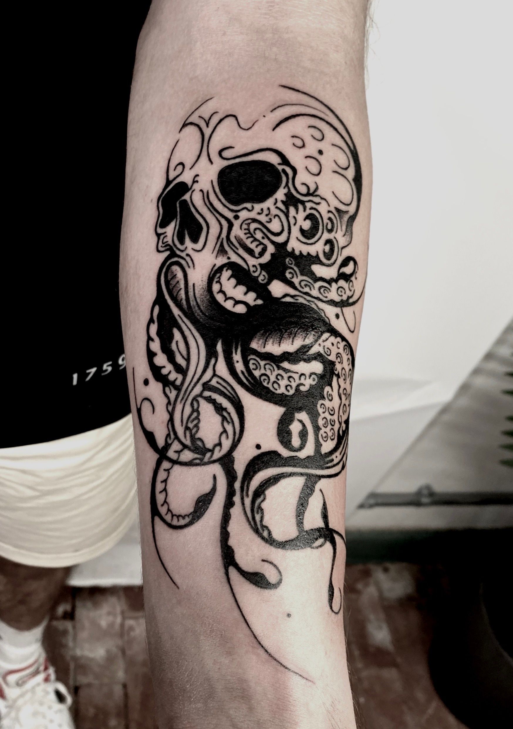 A colorful tattoo on a person's calf featuring Heimerdinger from League of Legends playing a guitar with goggles on.