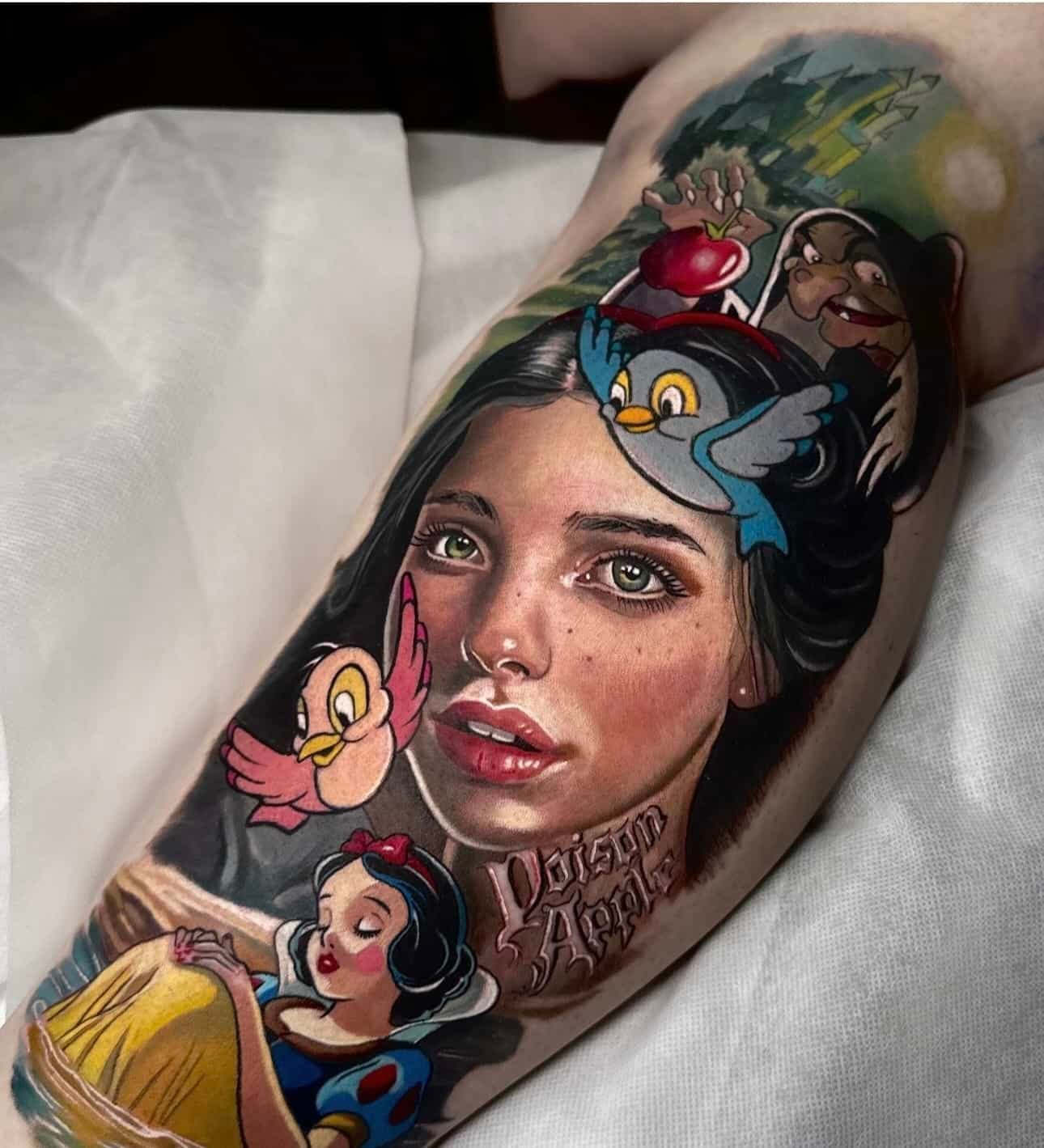 Colorful tattoo of Snow White, featuring a realistic portrait, cartoon characters, the Evil Queen, and an apple.
