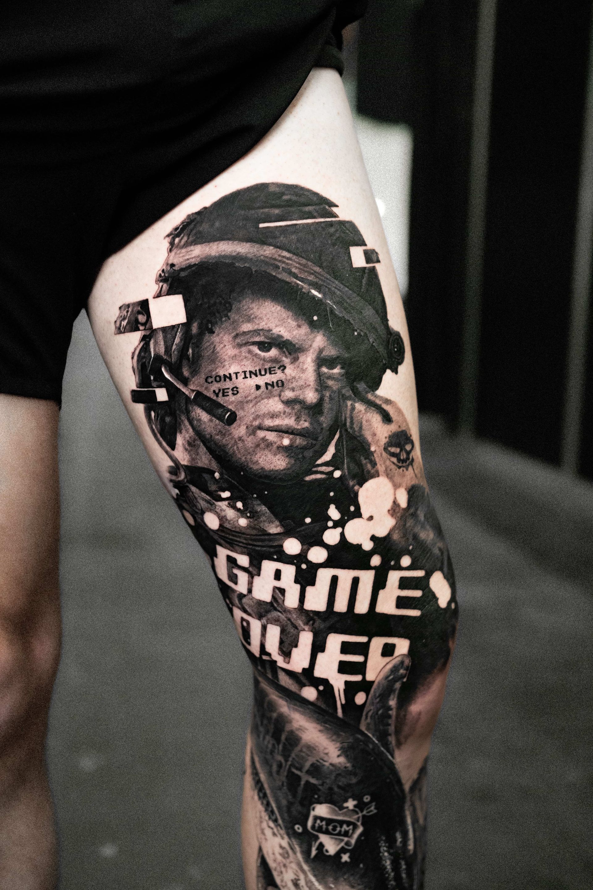 A detailed leg tattoo featuring a soldier in a helmet, the text 