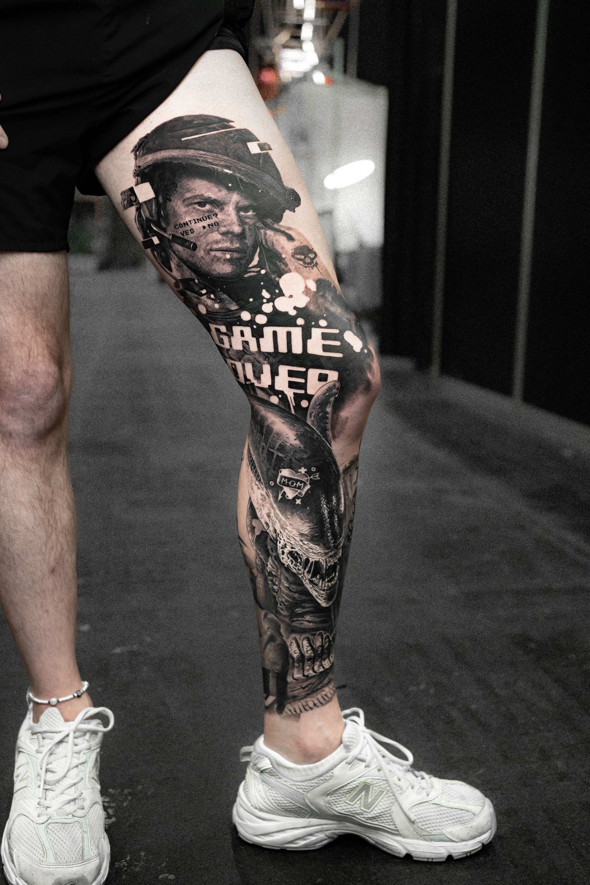 A leg tattoo featuring a soldier in a helmet, the words 