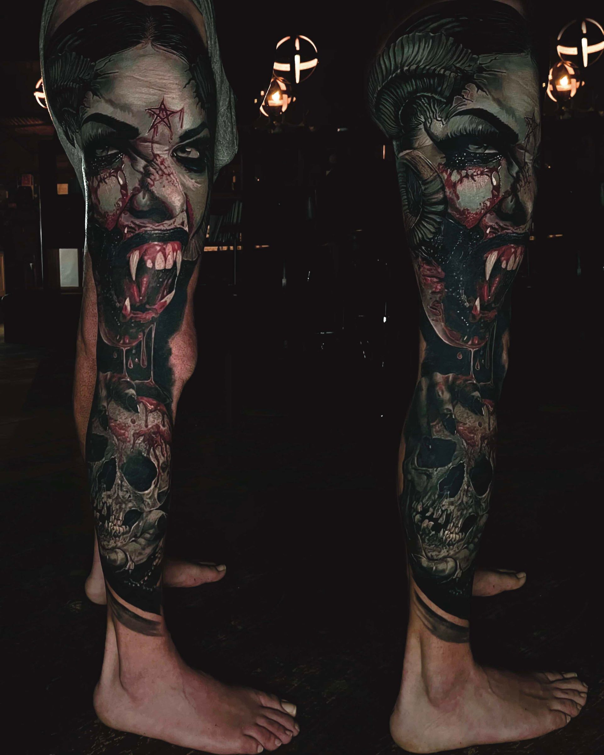 Leg tattoo featuring a dark, gothic portrait of a vampire with fangs and blood, over a detailed skull design.