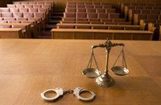 handcuffs and scales in court