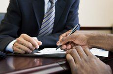 man signing leagl document
