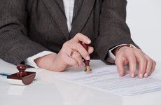 person stamping paperwork