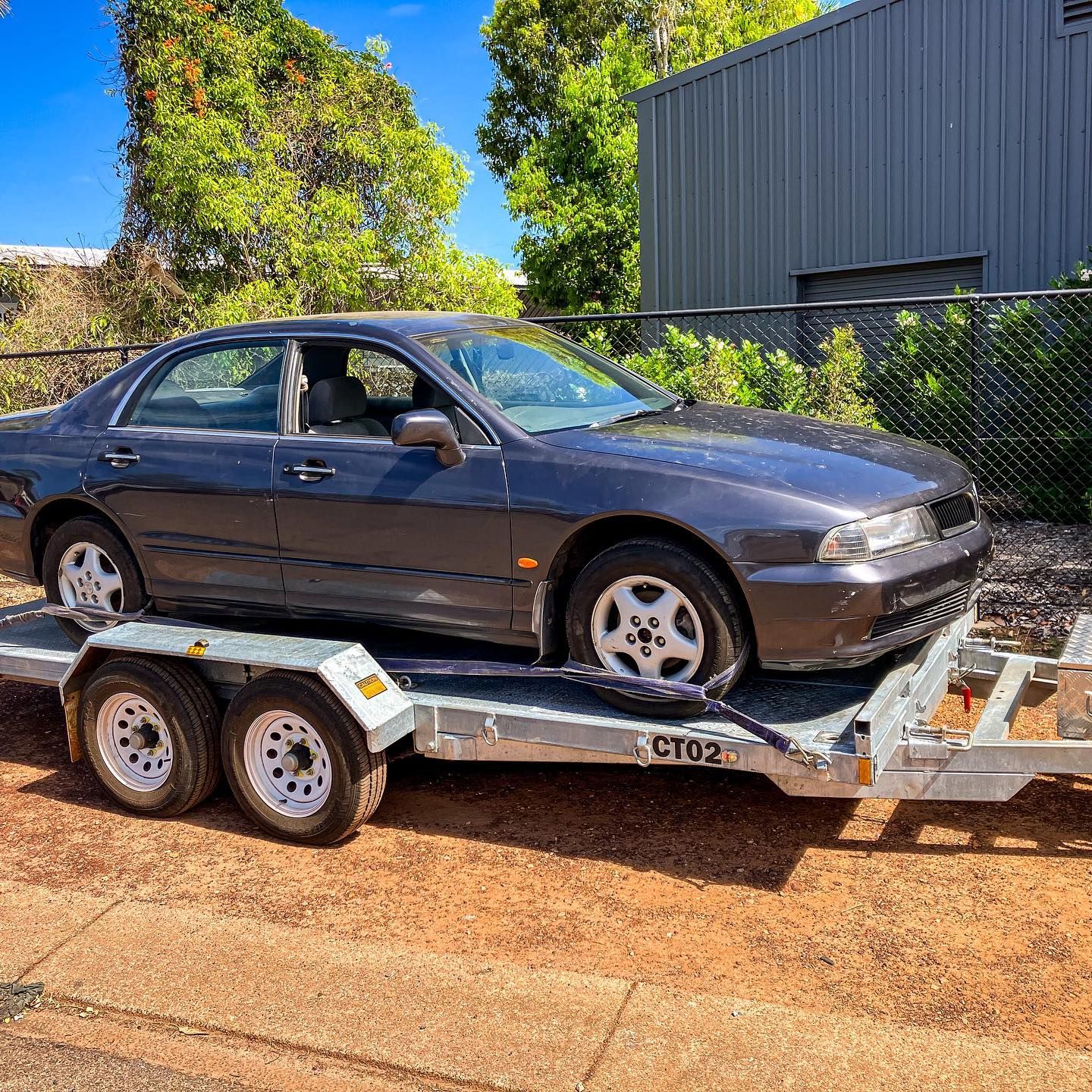 A Car Is Sitting On Top Of A Trailer — Fewmore Contracting in Palmerston, NT