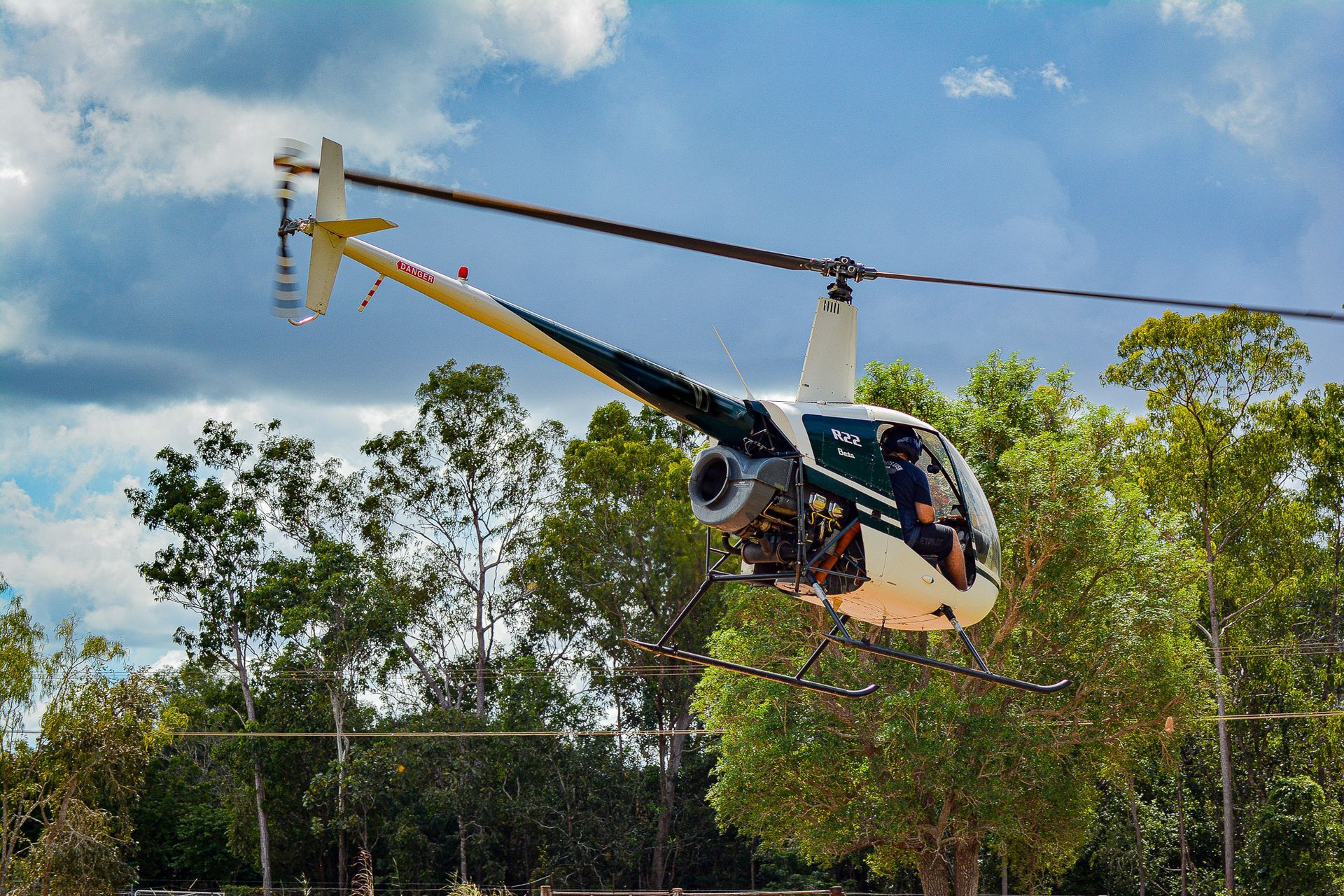 A Small Helicopter is Flying Over a Forest — Fewmore Contracting in Yarrawonga, NT