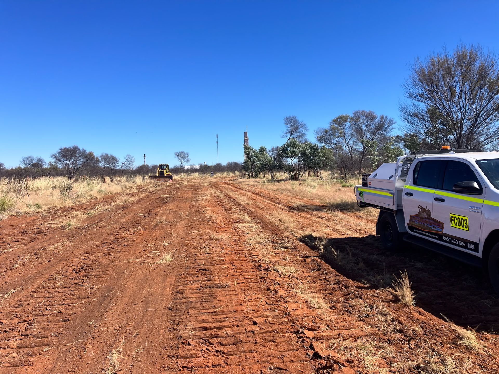 A White Truck is Parked on the Side of a Dirt Road — Fewmore Contracting in Humpty Doo, NT