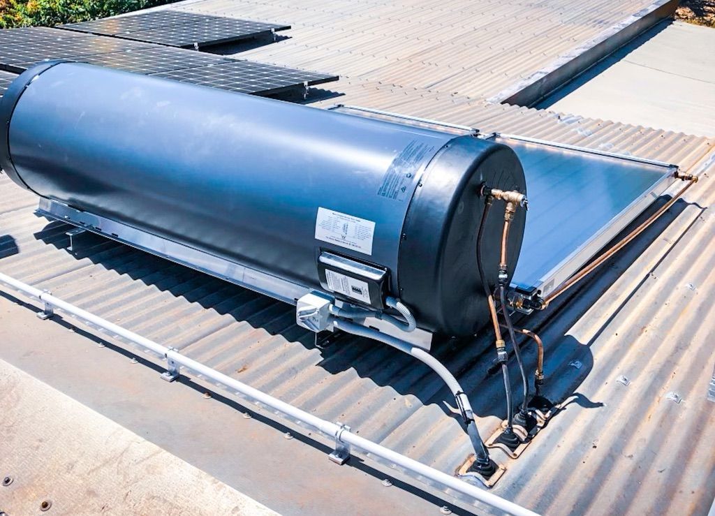 A Solar Water Heater is Sitting on Top of a Roof — Fewmore Contracting in Yarrawonga, NT