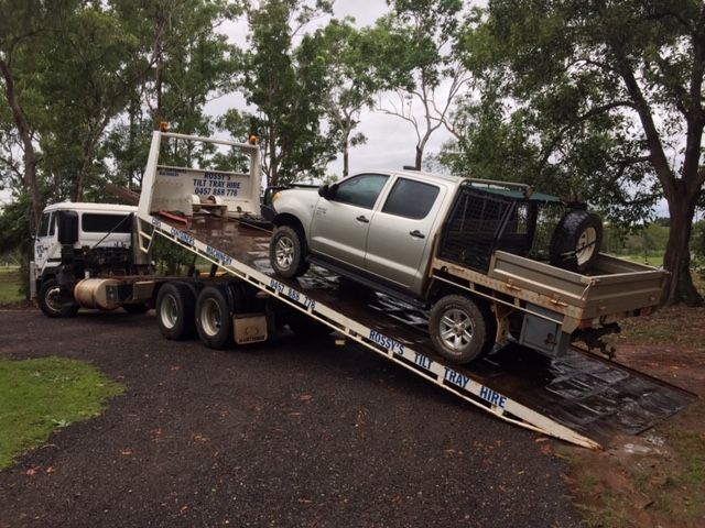 A Truck is Being Towed Down a Ramp by a Tow Truck — Fewmore Contracting in Humpty Doo, NT