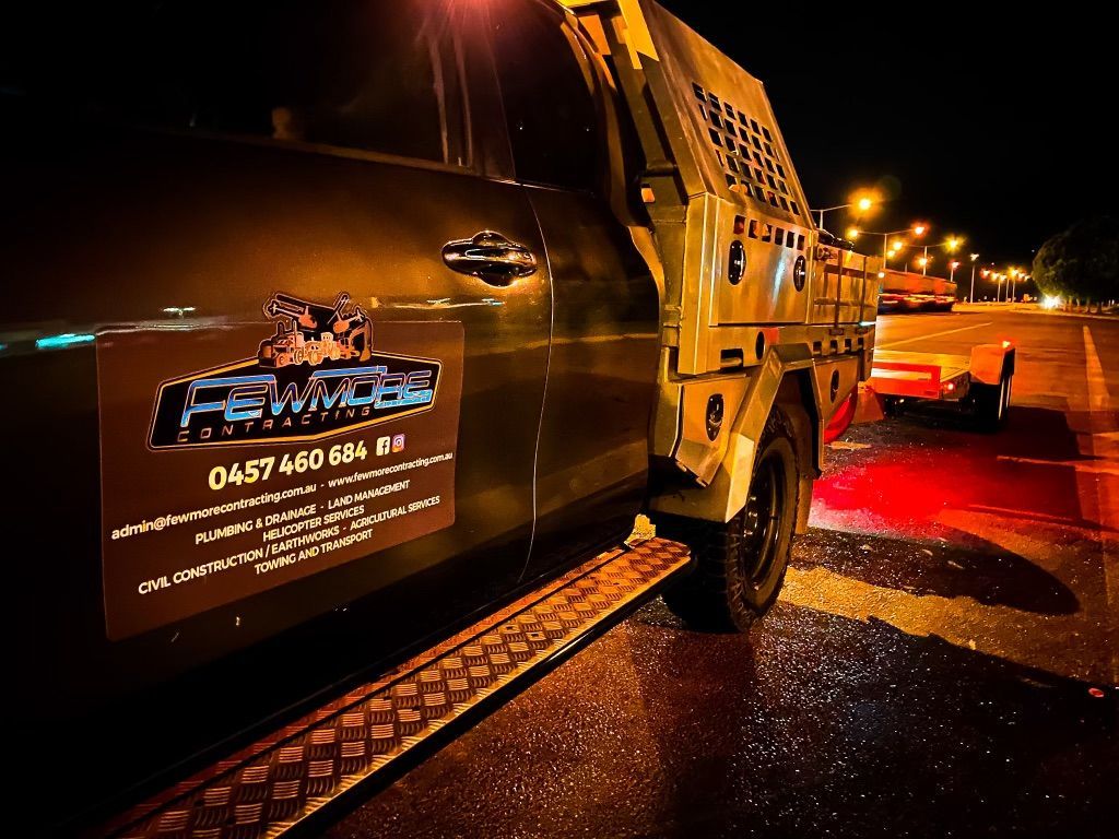 A Truck is Parked on the Side of the Road at Night — Fewmore Contracting In Tennant Creek, NT