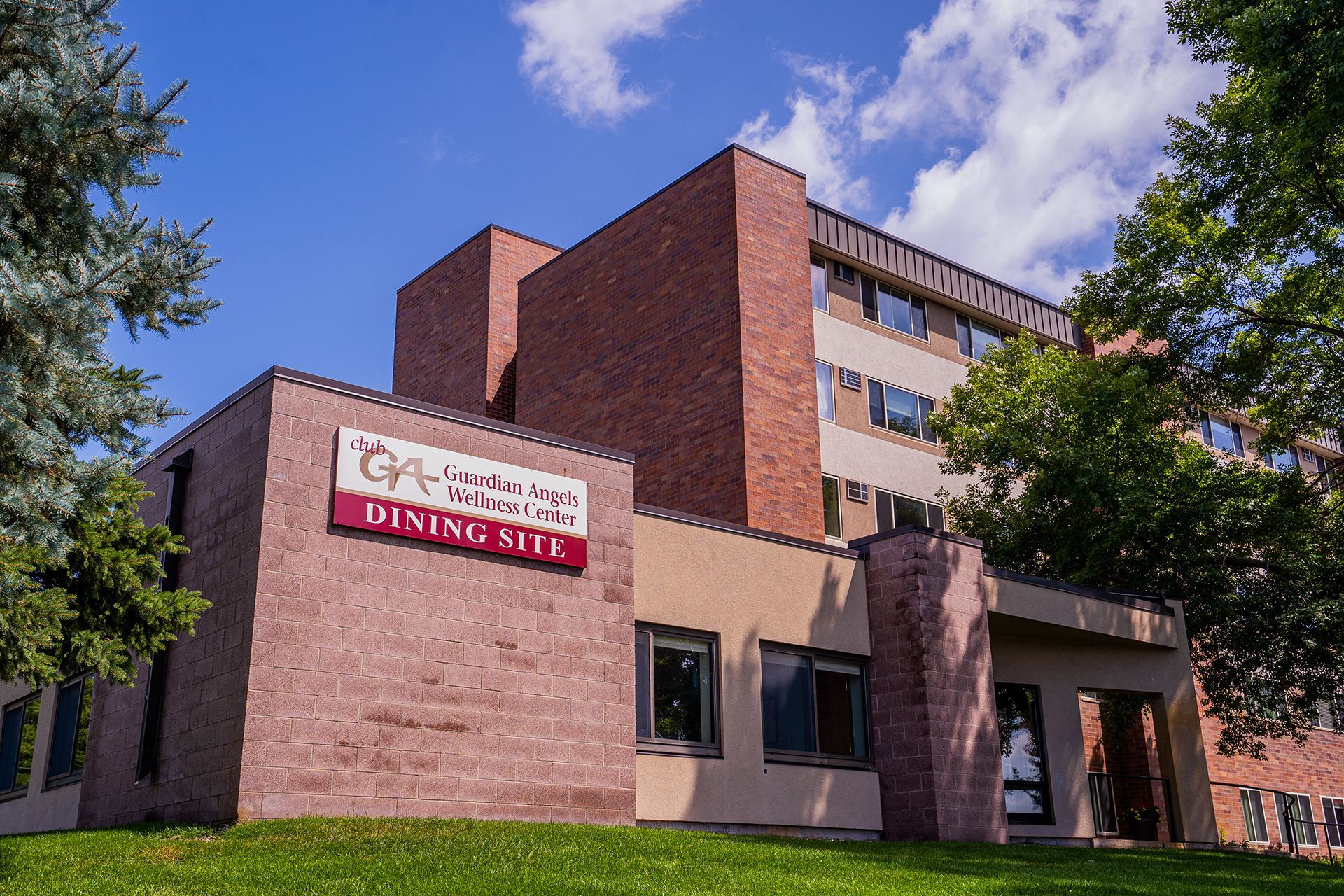 A multi-story brick building with a sign that reads