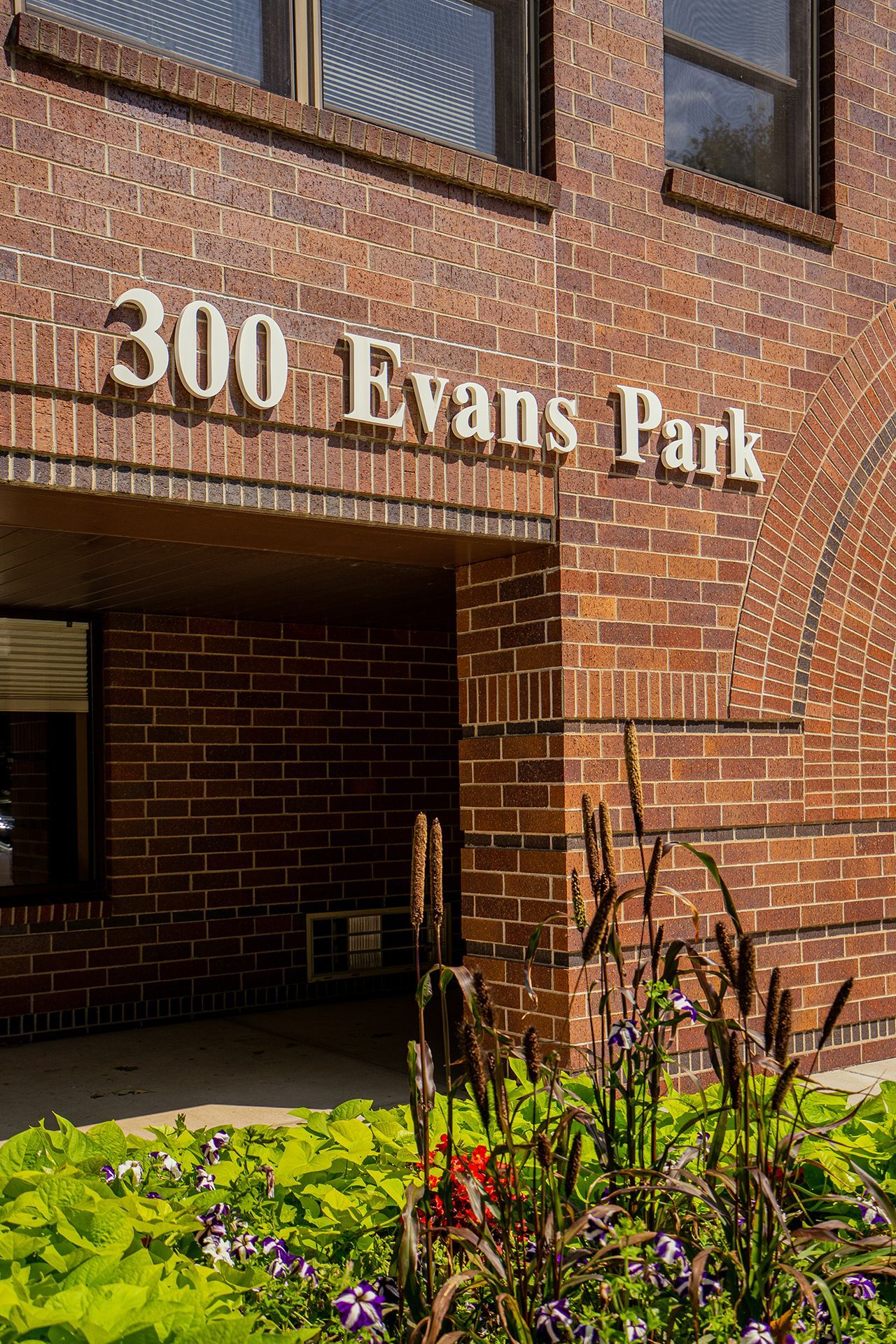 A brown brick building entrance marked 
