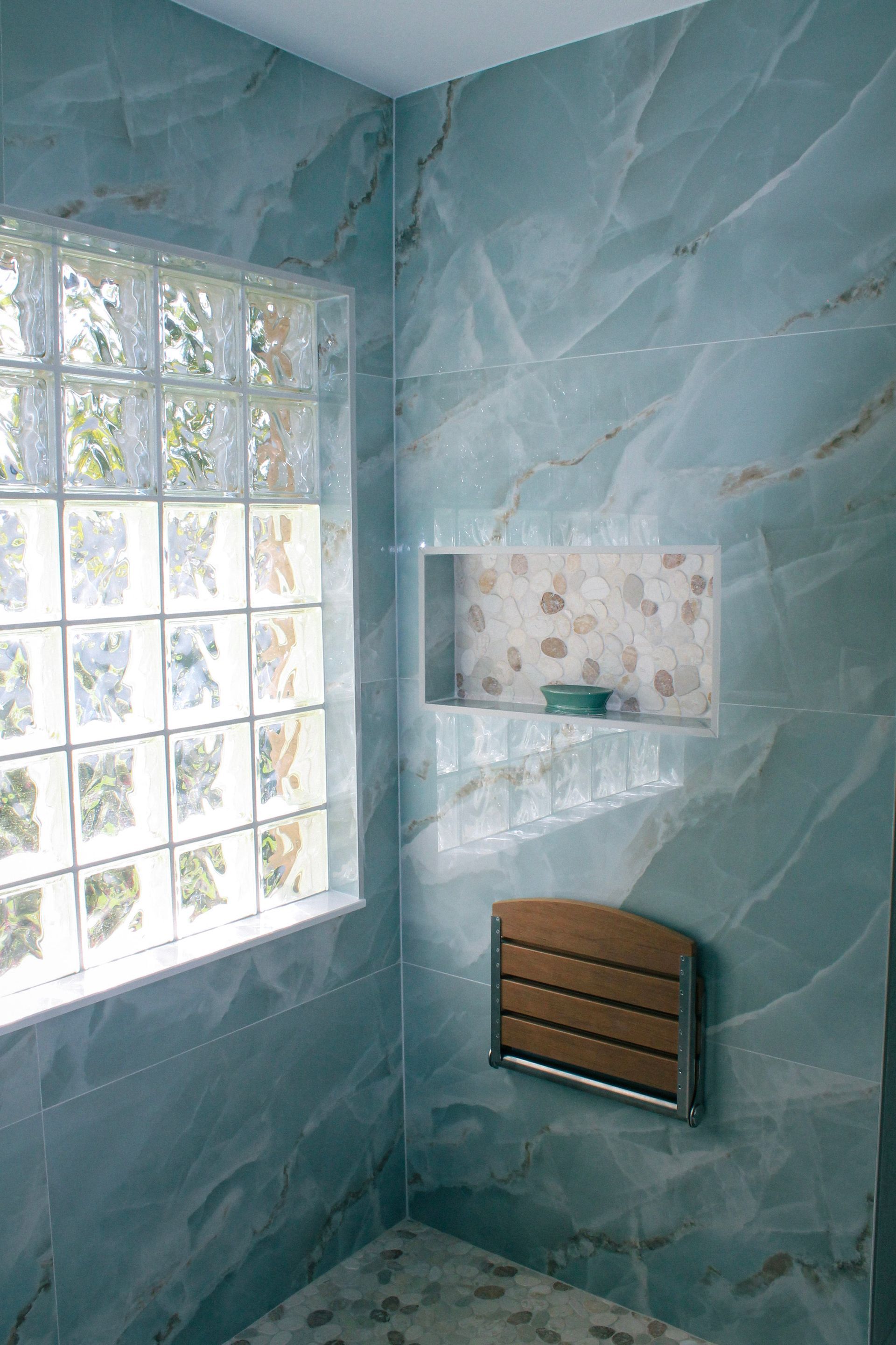 Modern blue tile bathroom with glass block window, white grout, steel and wood bench, Niche with white trims and mosaic, modern mosaic flooring with white grout