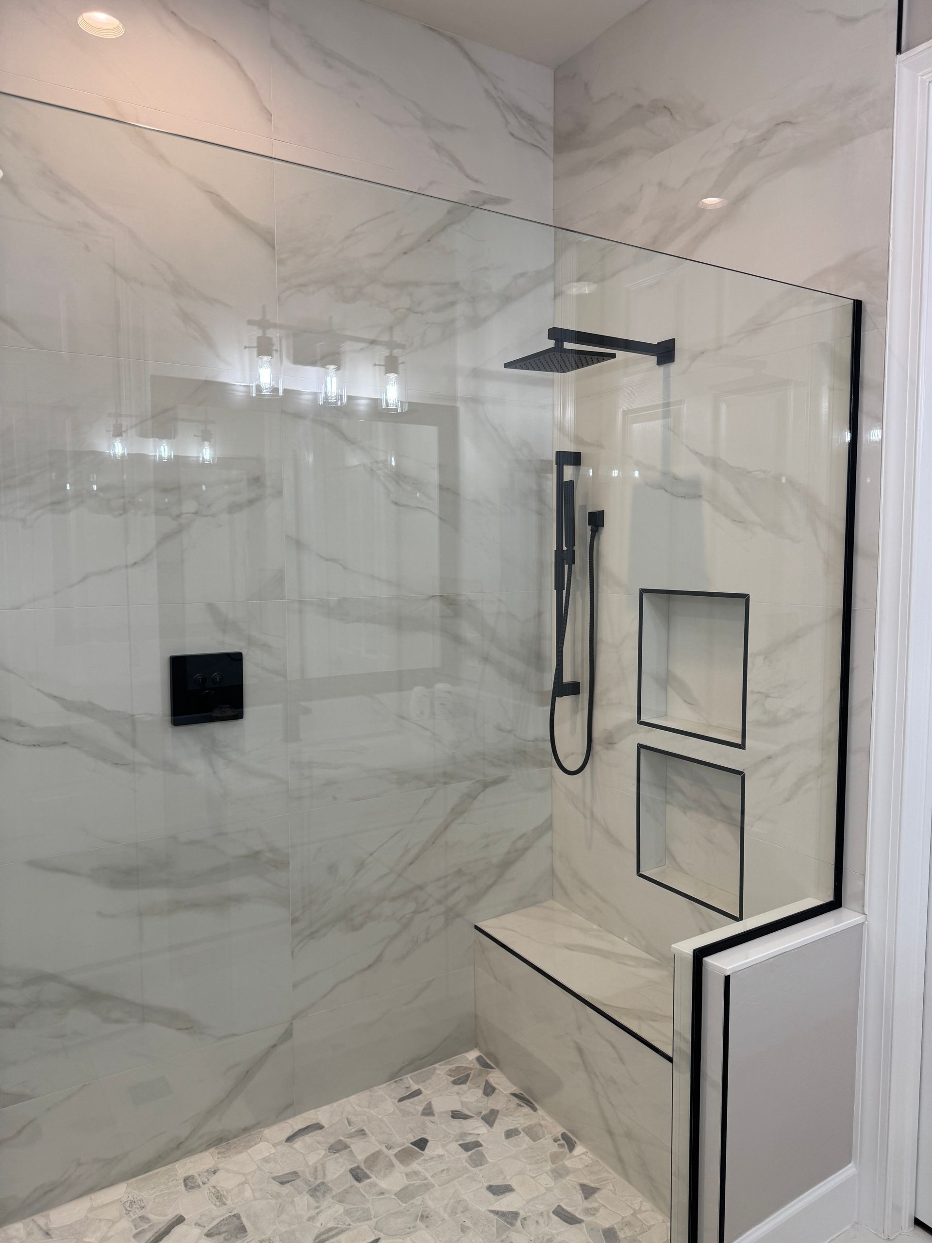 high-resolution photo of a completed Naples/Bonita bathroom featuring heavy frameless glass