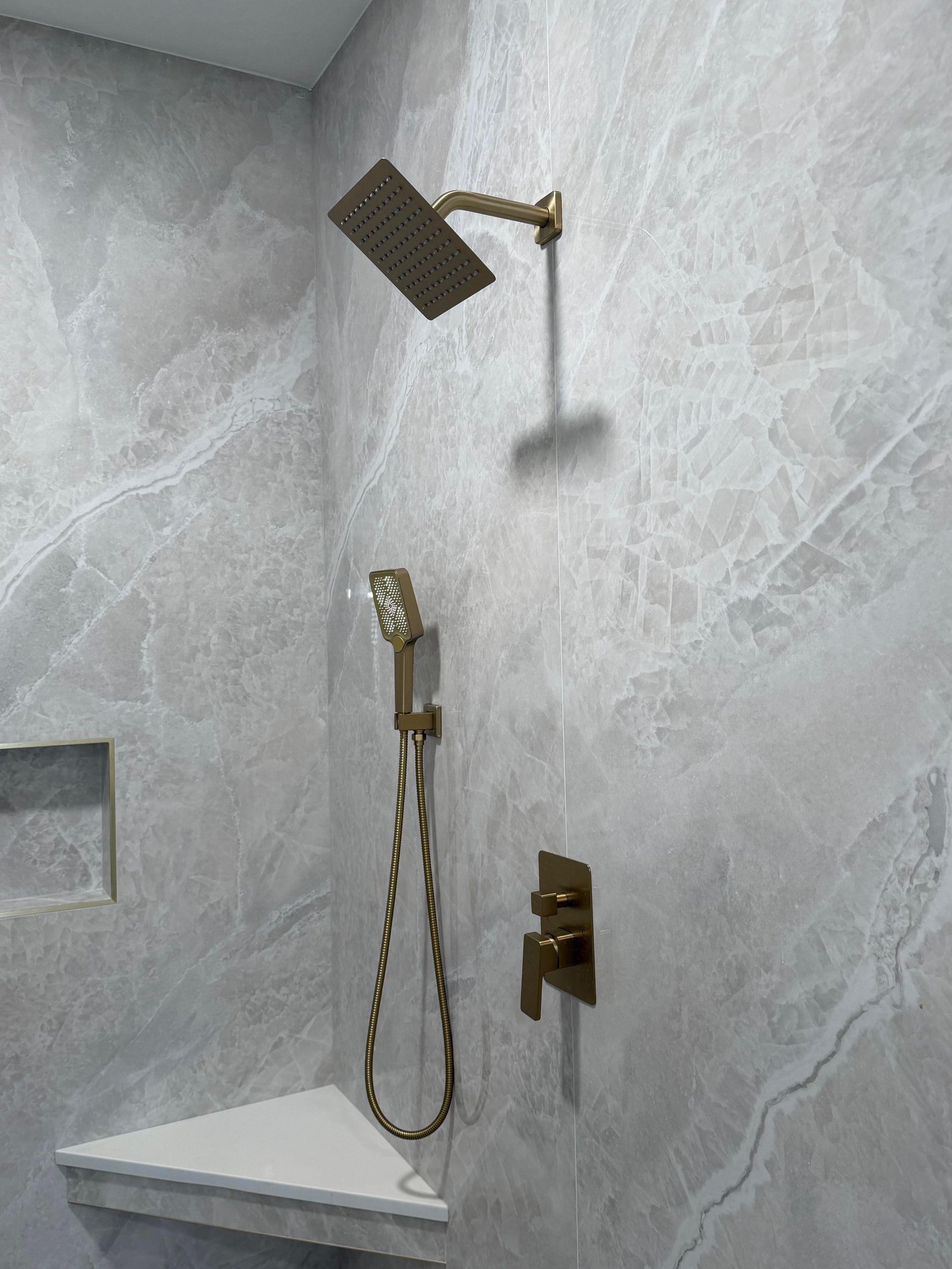 110''x48'' tile, shower, with brushed gold hardware, tile shower seat, with built in niche, shower and separate spray.