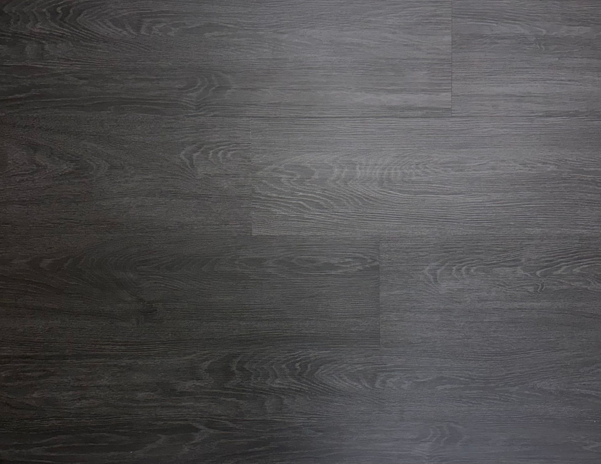 A close up of a black wooden floor.