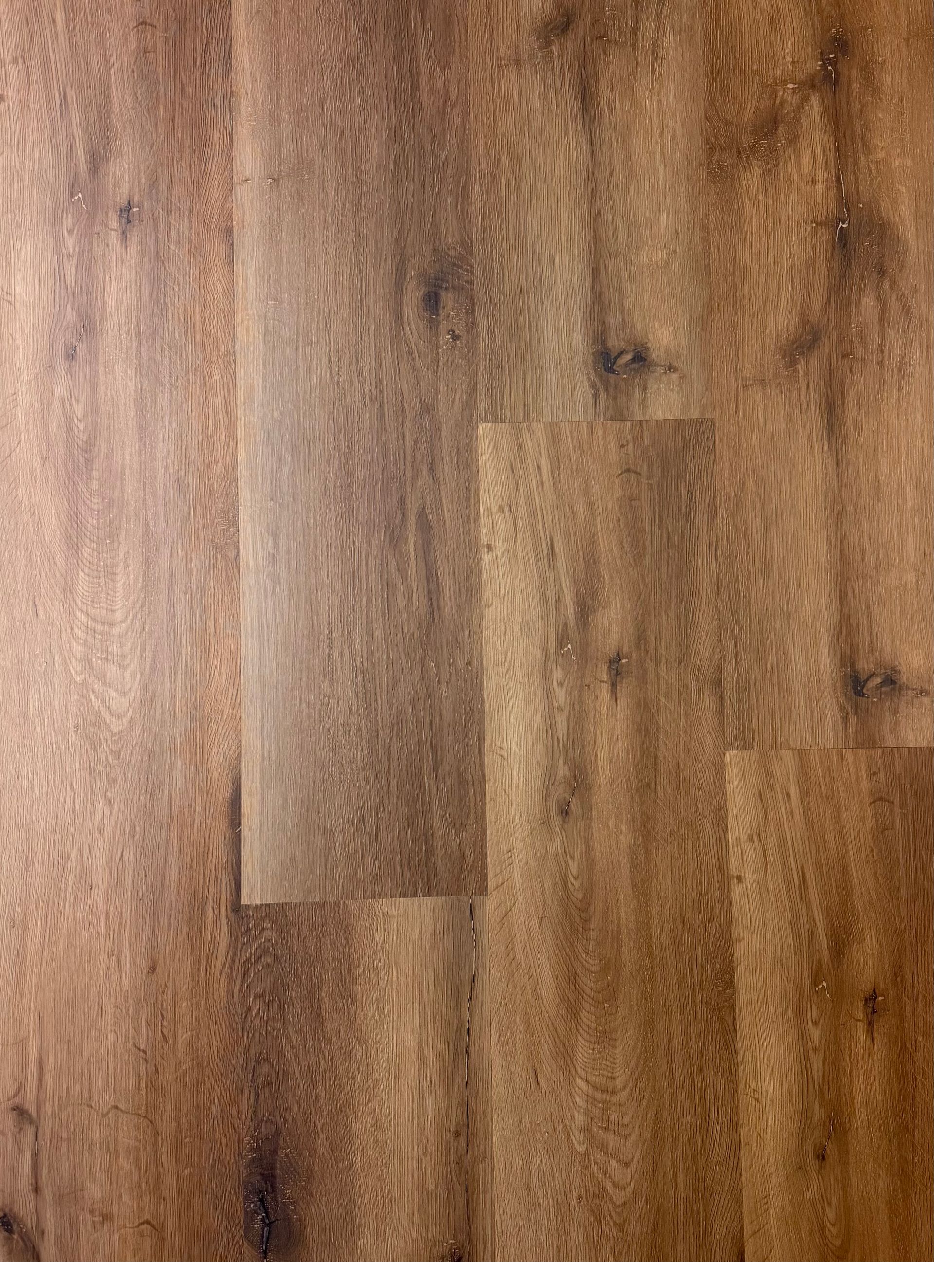 A close up of a wooden floor with a grainy texture.