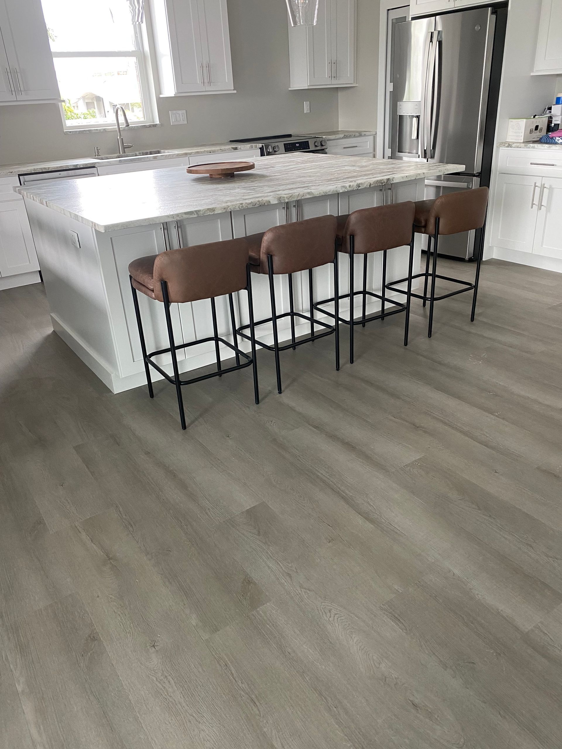 A kitchen with a large island and stools
