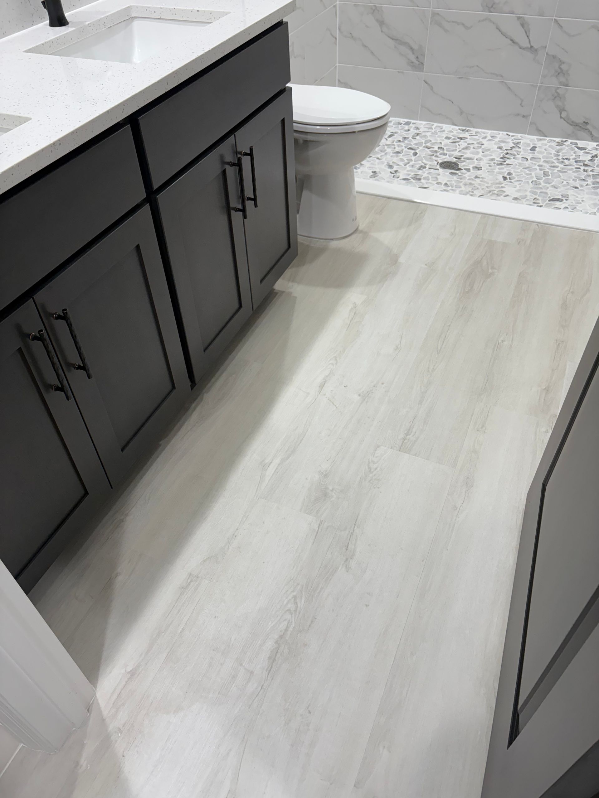 A bathroom with a sink , toilet , and shower.