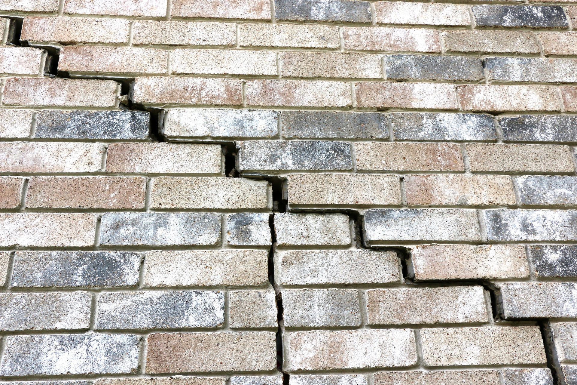 Stair-step crack in a brick wall signaling pier and beam foundation problems in Houston Stair-step crack in a brick wall signaling pier and beam foundation problems in Houston