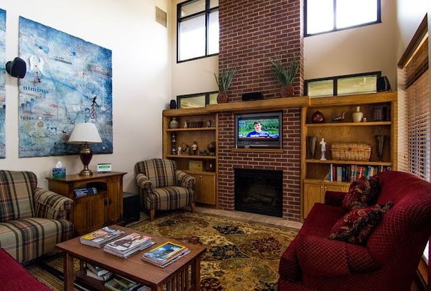 a living room with a fireplace and a television
