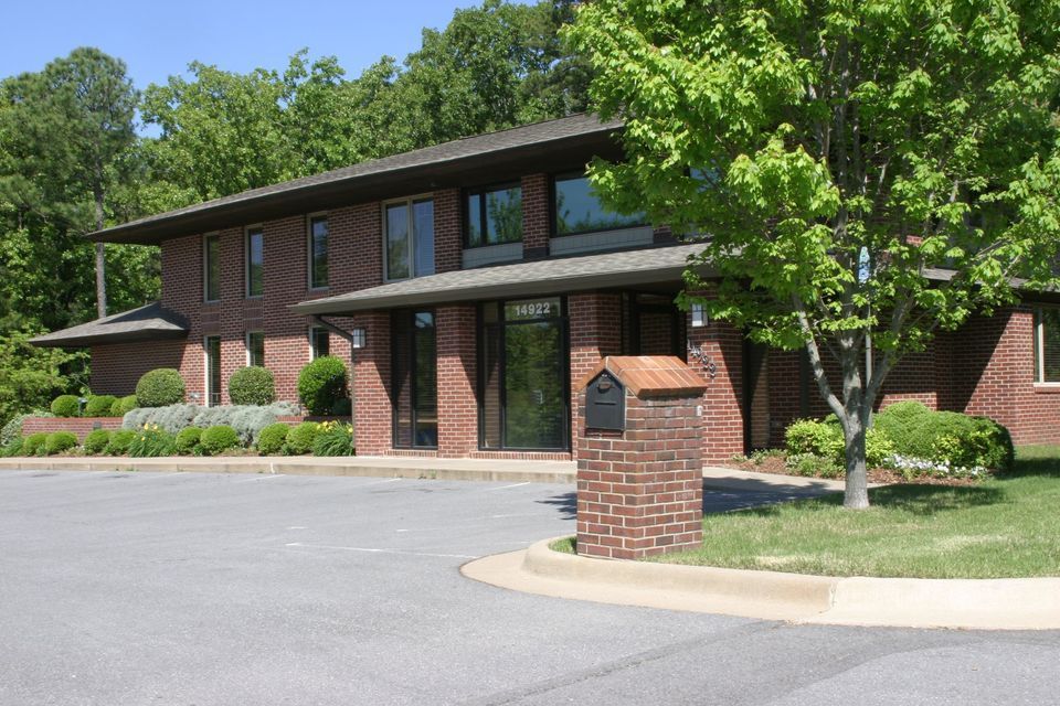 A large brick building with a mailbox in front of it