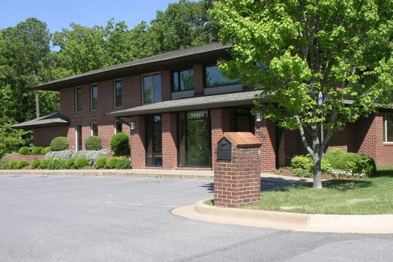 a large brick building with a mailbox in front of it