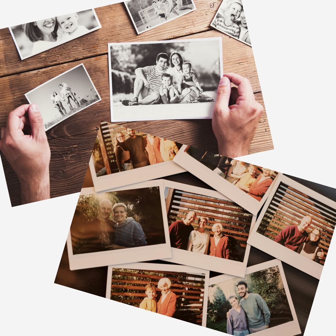 Hands holding and displaying family photographs on a wooden surface.